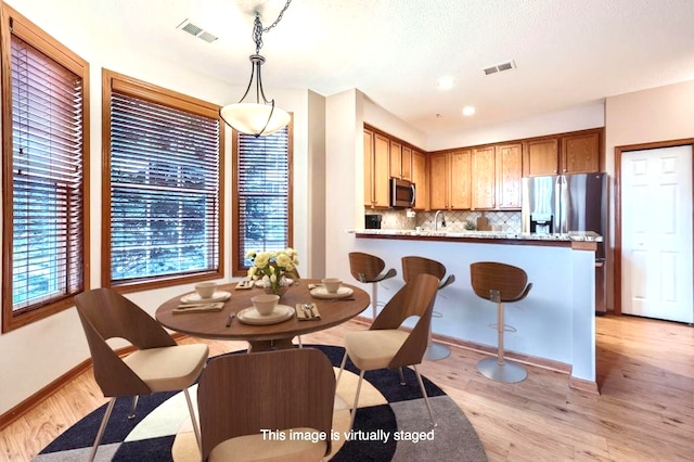 dining area with light hardwood / wood-style floors