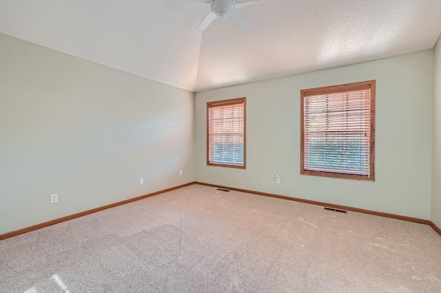 spare room with carpet, ceiling fan, and lofted ceiling