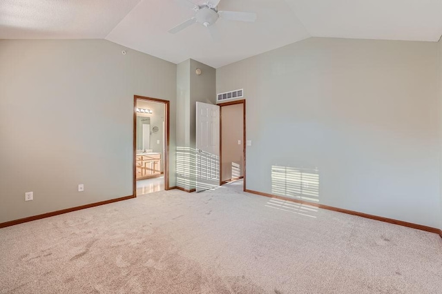 unfurnished bedroom with carpet flooring, ensuite bath, ceiling fan, and lofted ceiling