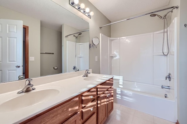 bathroom featuring tile patterned floors, vanity,  shower combination, and a textured ceiling