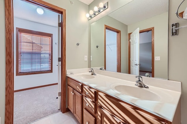 bathroom with tile patterned flooring and vanity