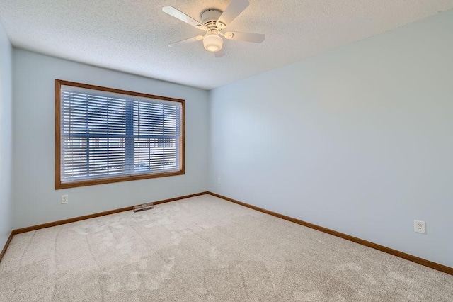 empty room with light colored carpet and ceiling fan