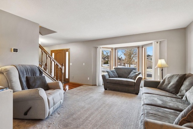 carpeted living room with a textured ceiling