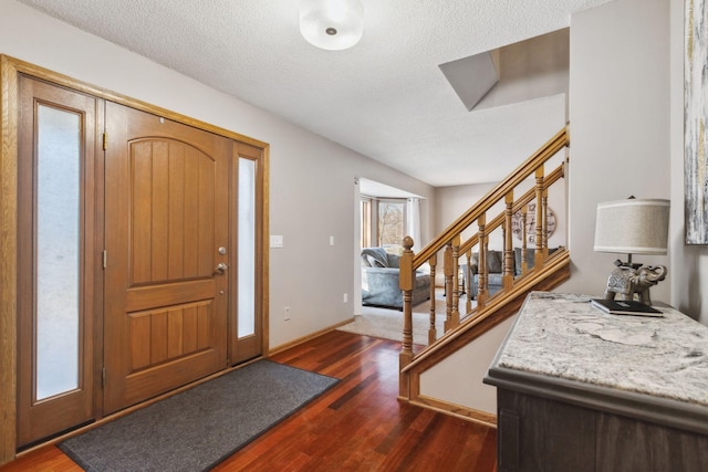 entrance foyer featuring dark hardwood / wood-style floors and a textured ceiling