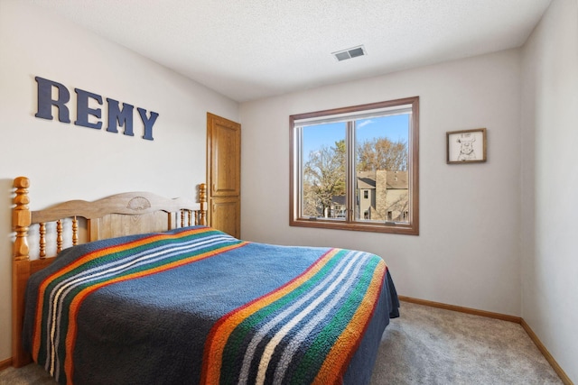 carpeted bedroom with a textured ceiling