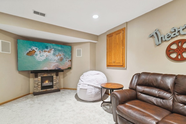 living area featuring light carpet and a fireplace