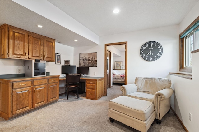 office area featuring light carpet and a textured ceiling