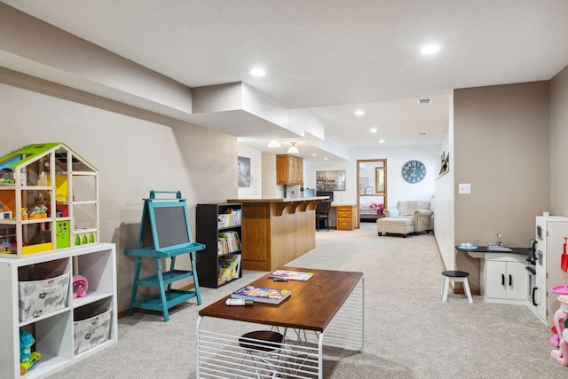 recreation room featuring light colored carpet