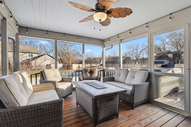 sunroom / solarium featuring rail lighting, wooden ceiling, and ceiling fan