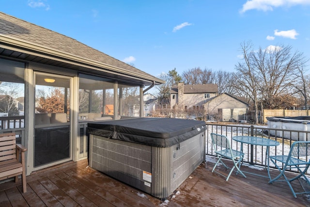 wooden deck with a swimming pool with hot tub and a sunroom