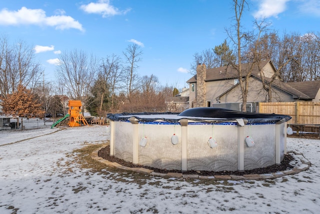 snow covered pool featuring a playground