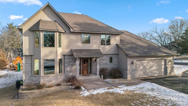 view of front of house featuring a garage and central AC unit