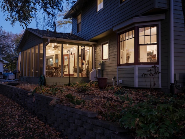 view of side of home featuring a sunroom