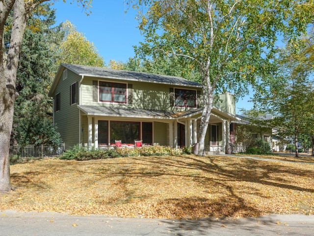 view of front of house with a porch and a front yard