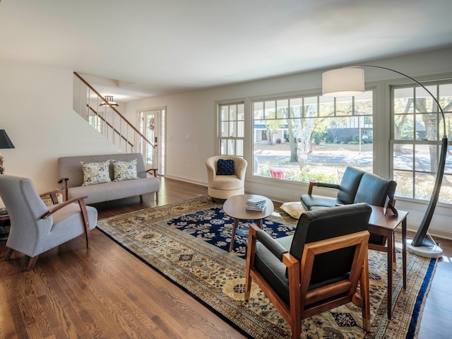 living room featuring an inviting chandelier and dark hardwood / wood-style flooring