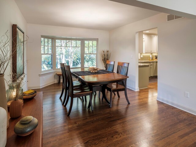 dining area with dark wood-type flooring