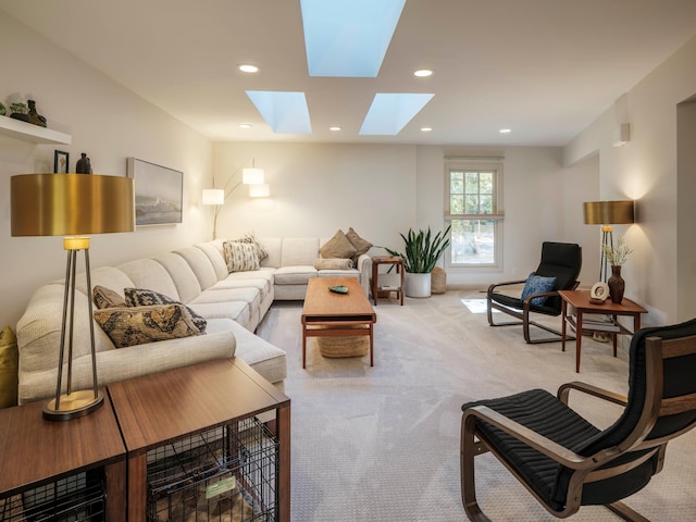 living room featuring a skylight and light colored carpet