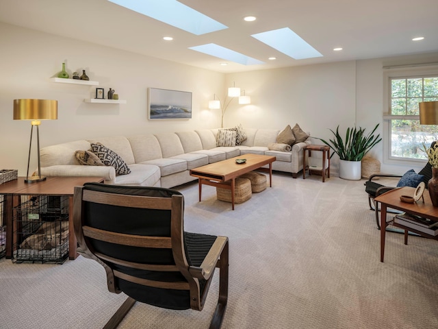 carpeted living room with a skylight