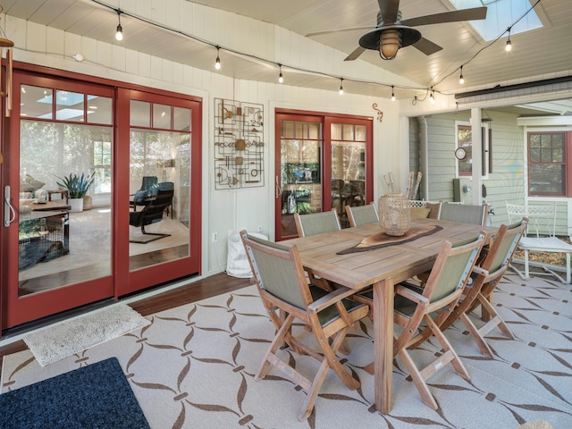 sunroom / solarium featuring ceiling fan and a skylight