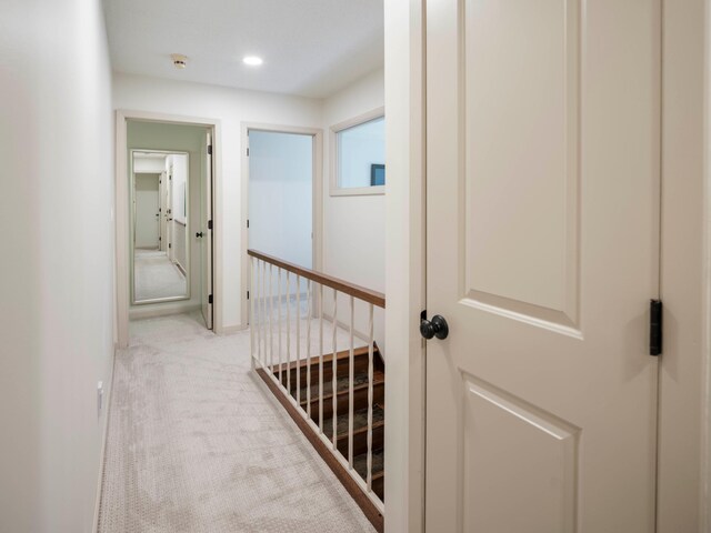 hall featuring light colored carpet