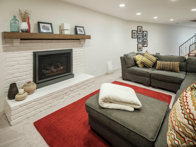 carpeted living room with a brick fireplace