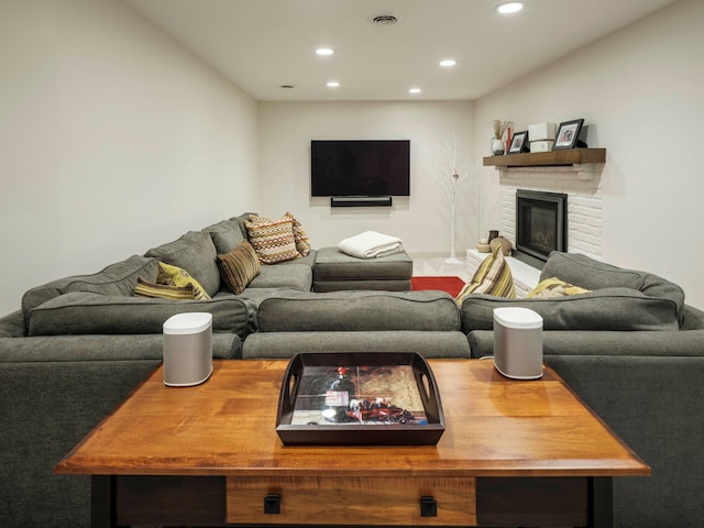 living room featuring a brick fireplace