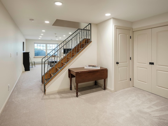 stairway featuring carpet