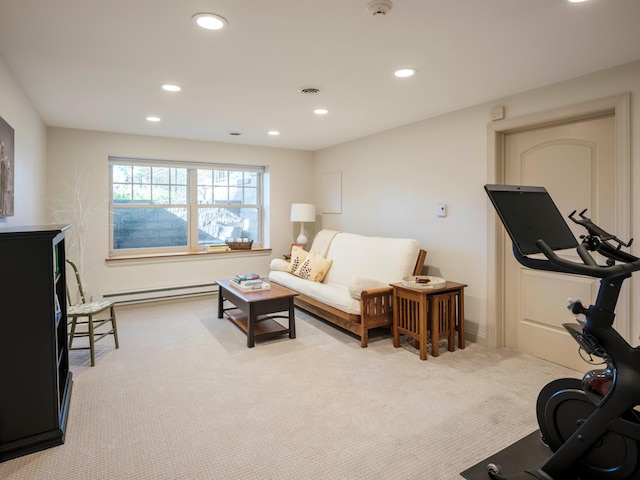 exercise area with baseboard heating and light carpet