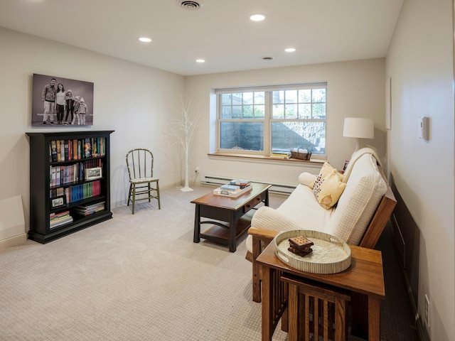 living area featuring light colored carpet and baseboard heating