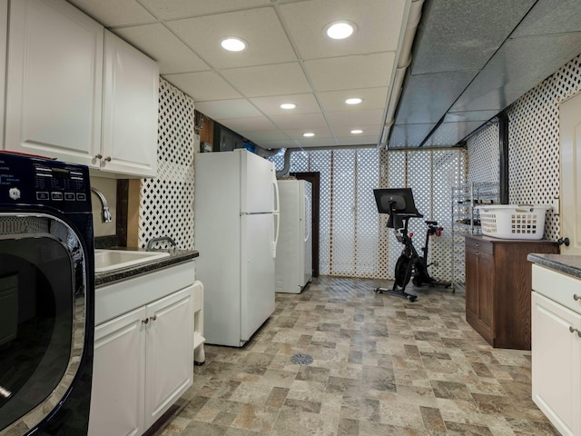 clothes washing area with washer / clothes dryer and sink