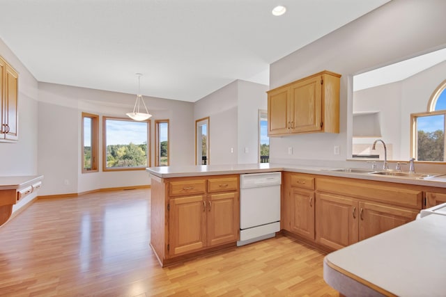 kitchen featuring sink, light hardwood / wood-style flooring, kitchen peninsula, white dishwasher, and decorative light fixtures