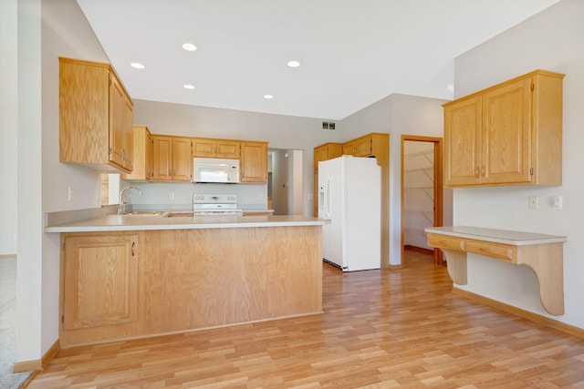 kitchen featuring kitchen peninsula, light wood-type flooring, white appliances, sink, and light brown cabinets