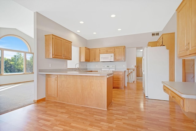 kitchen with sink, white appliances, kitchen peninsula, and light brown cabinetry