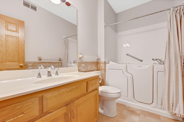 bathroom with tile patterned flooring, vanity, and toilet