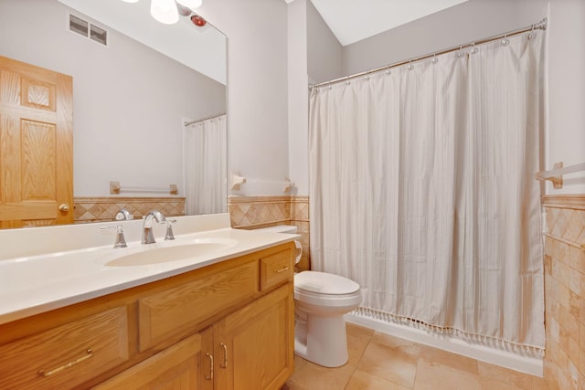 bathroom featuring tile patterned floors, vanity, toilet, and walk in shower