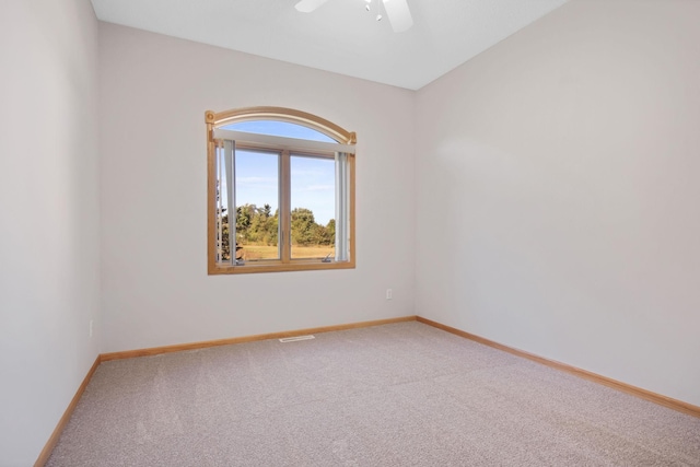 spare room with ceiling fan and carpet floors