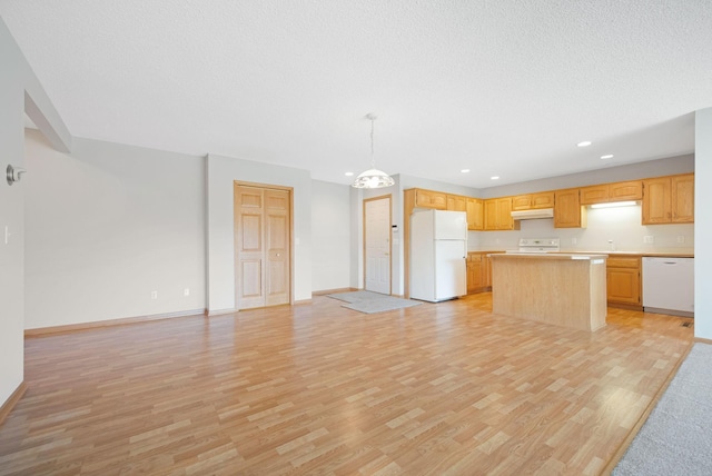 kitchen with light brown cabinets, a center island, light hardwood / wood-style flooring, decorative light fixtures, and white appliances