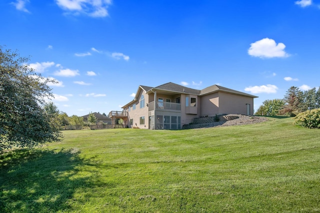 view of home's exterior with a lawn and a balcony