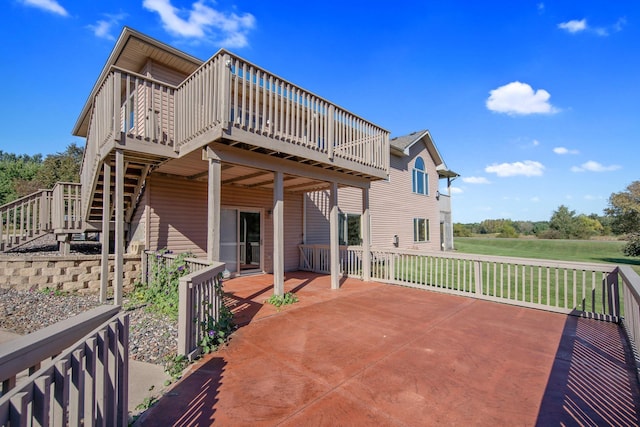 rear view of property featuring a patio and a wooden deck