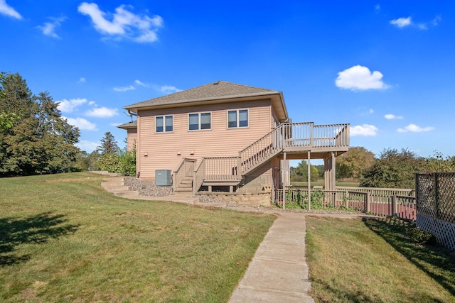 rear view of house featuring central air condition unit, a lawn, and a wooden deck