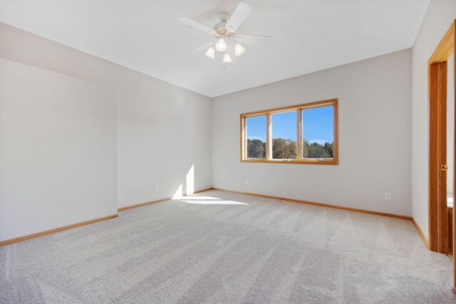 16377 Eidelweiss St NW, Andover, MN 55304 - empty room featuring light colored carpet, ceiling fan, and baseboards