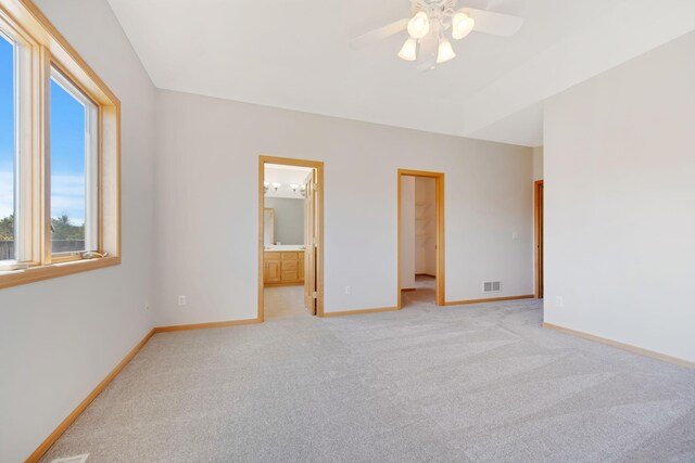 16377 Eidelweiss St NW, Andover, MN 55304 - unfurnished bedroom featuring connected bathroom, light colored carpet, a spacious closet, visible vents, and baseboards