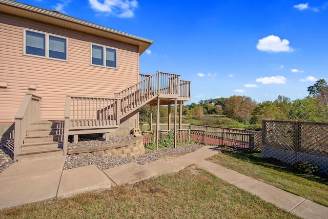 16377 Eidelweiss St NW, Andover, MN 55304 - view of side of home with stairs, a wooden deck, and fence