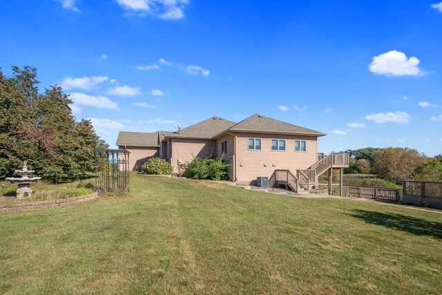 16377 Eidelweiss St NW, Andover, MN 55304 - rear view of property featuring fence, cooling unit, a shingled roof, and a lawn