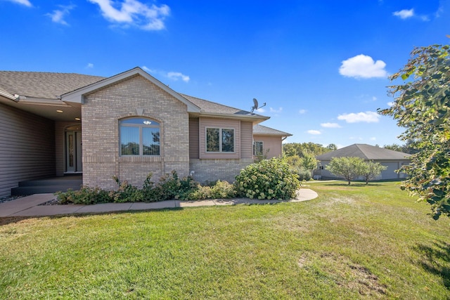 16377 Eidelweiss St NW, Andover, MN 55304 - view of side of home with a lawn and brick siding
