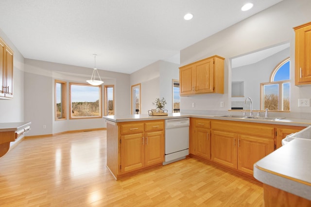16377 Eidelweiss St NW, Andover, MN 55304 - kitchen featuring a peninsula, light wood-type flooring, light countertops, a sink, and white dishwasher