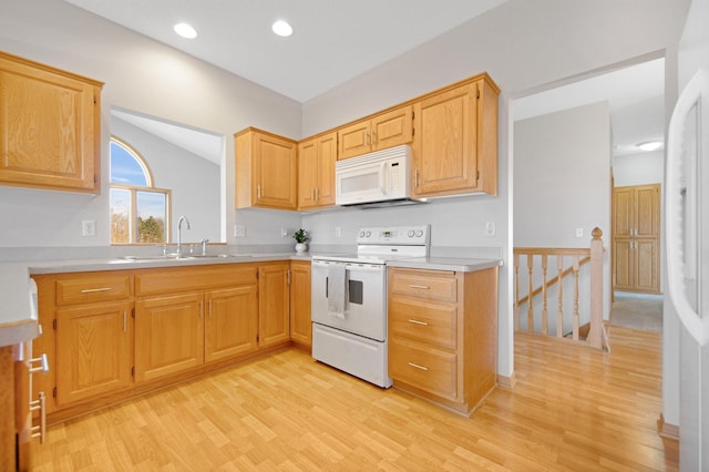 16377 Eidelweiss St NW, Andover, MN 55304 - kitchen with a sink, light countertops, white appliances, light wood finished floors, and recessed lighting