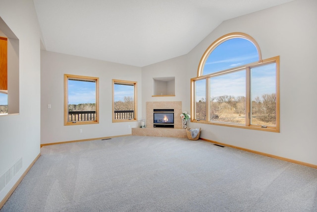 16377 Eidelweiss St NW, Andover, MN 55304 - unfurnished living room featuring visible vents, vaulted ceiling, carpet floors, a premium fireplace, and baseboards