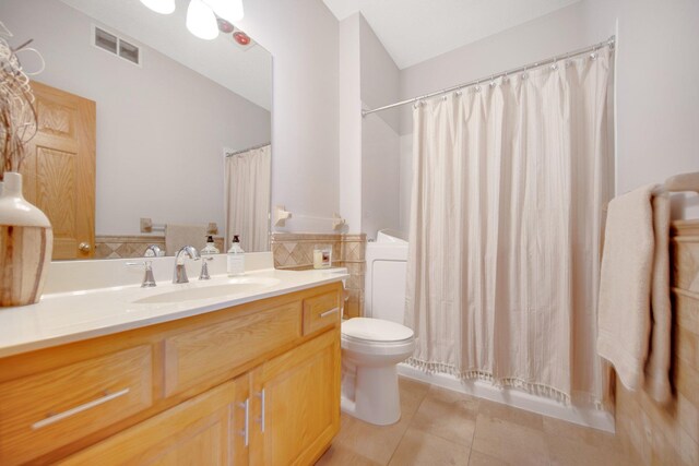 16377 Eidelweiss St NW, Andover, MN 55304 - full bath with vanity, tile patterned flooring, toilet, visible vents, and tile walls