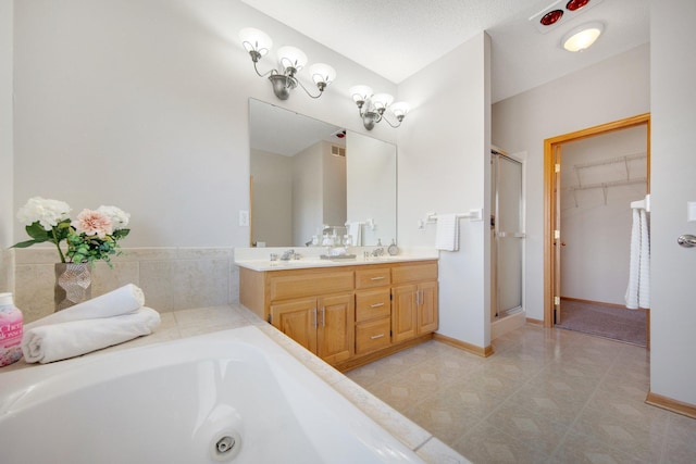 16377 Eidelweiss St NW, Andover, MN 55304 - bathroom featuring a bath, double vanity, a stall shower, and baseboards
